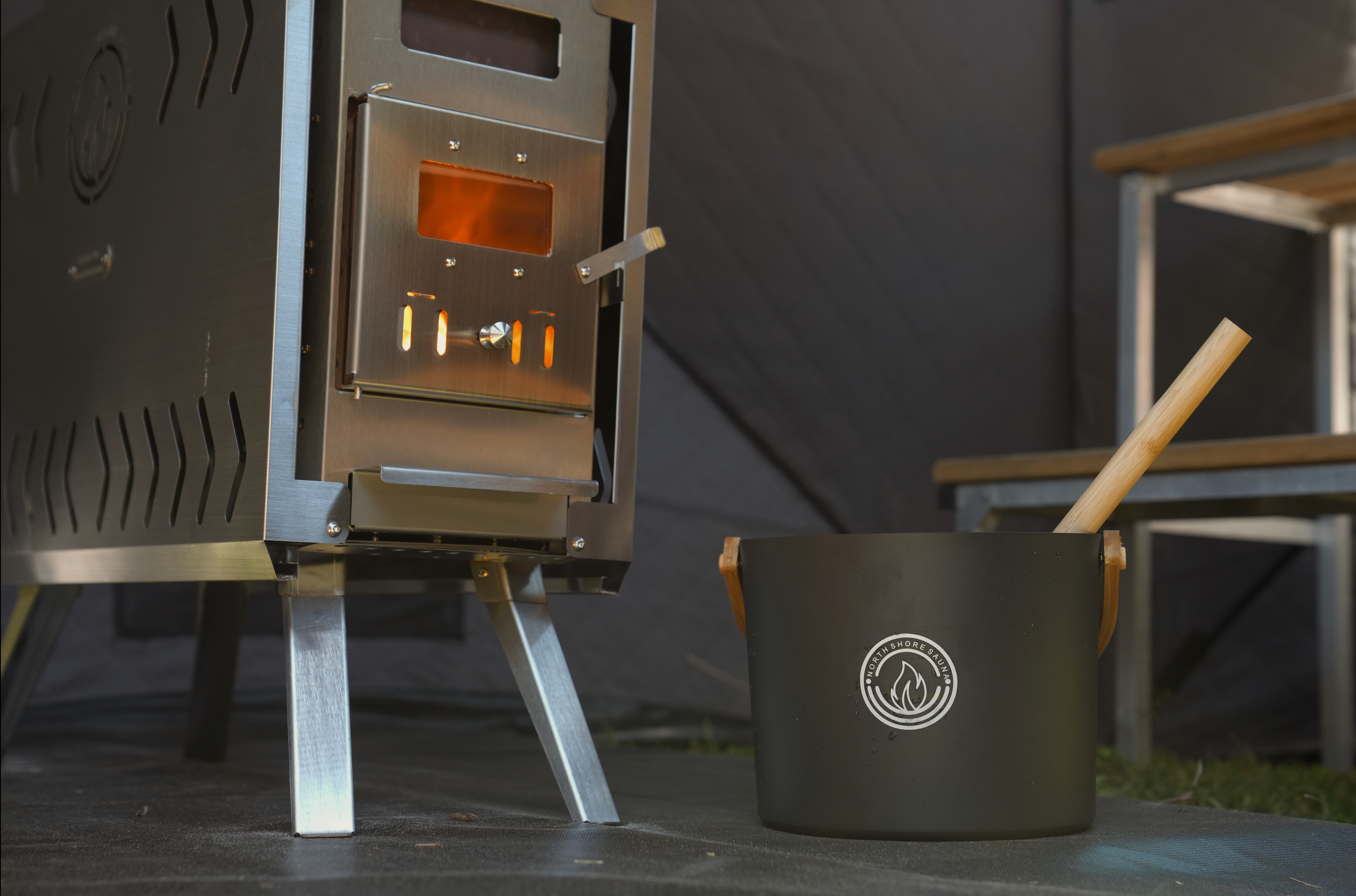 Wood-burning mini stove inside Mini Cube sauna tent reaching 200 degrees Fahrenheit in 15 minutes