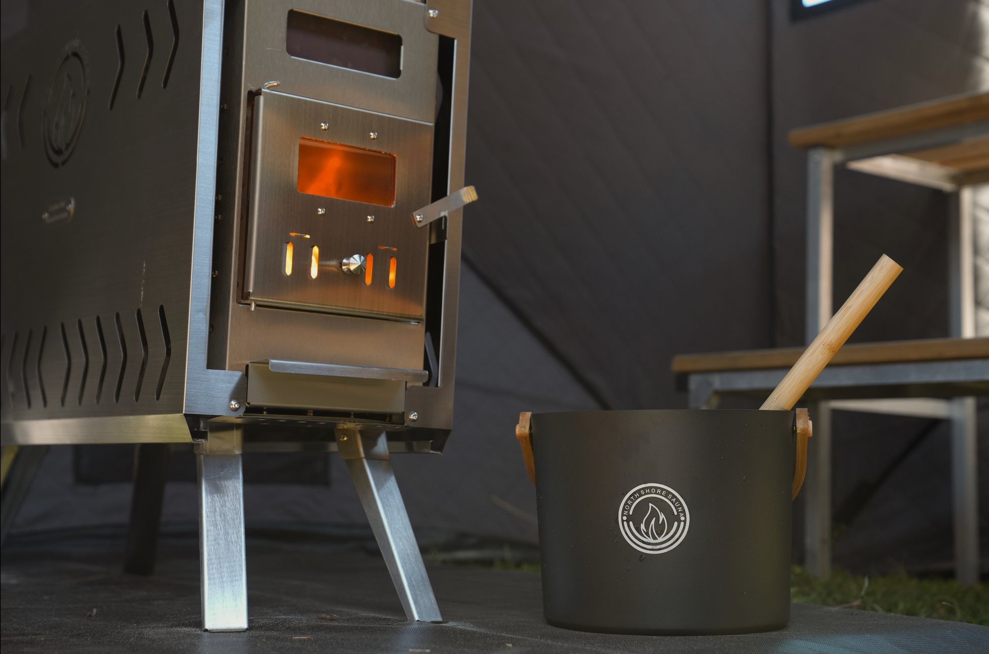 Wood-burning stove inside Nova 4 portable sauna tent reaching 200 degrees Fahrenheit