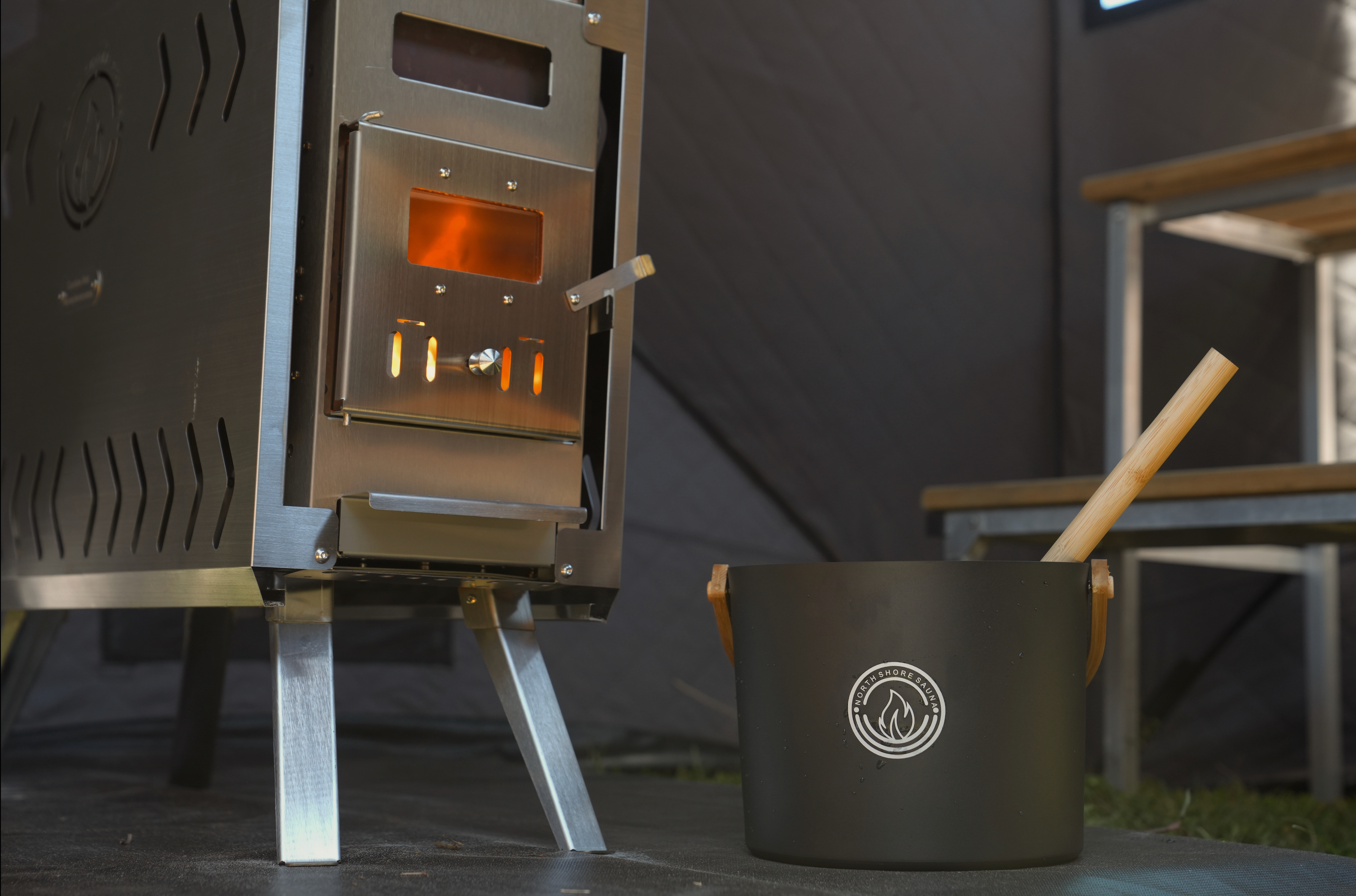 Wood-burning stove inside Nova 4 portable sauna tent reaching 200 degrees Fahrenheit