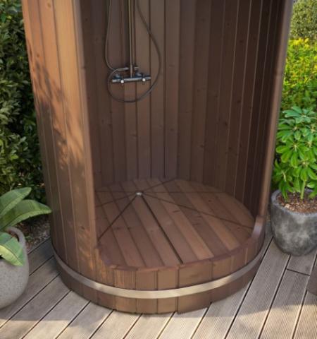 Wooden outdoor shower enclosure with plants in the background