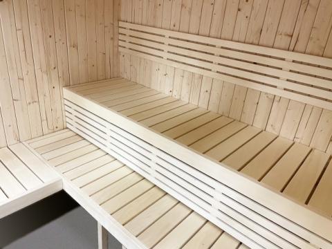 SaunaLife X7 interior showing dual-tier grade-A knotless Aspen benches footrest and full glass front natural light